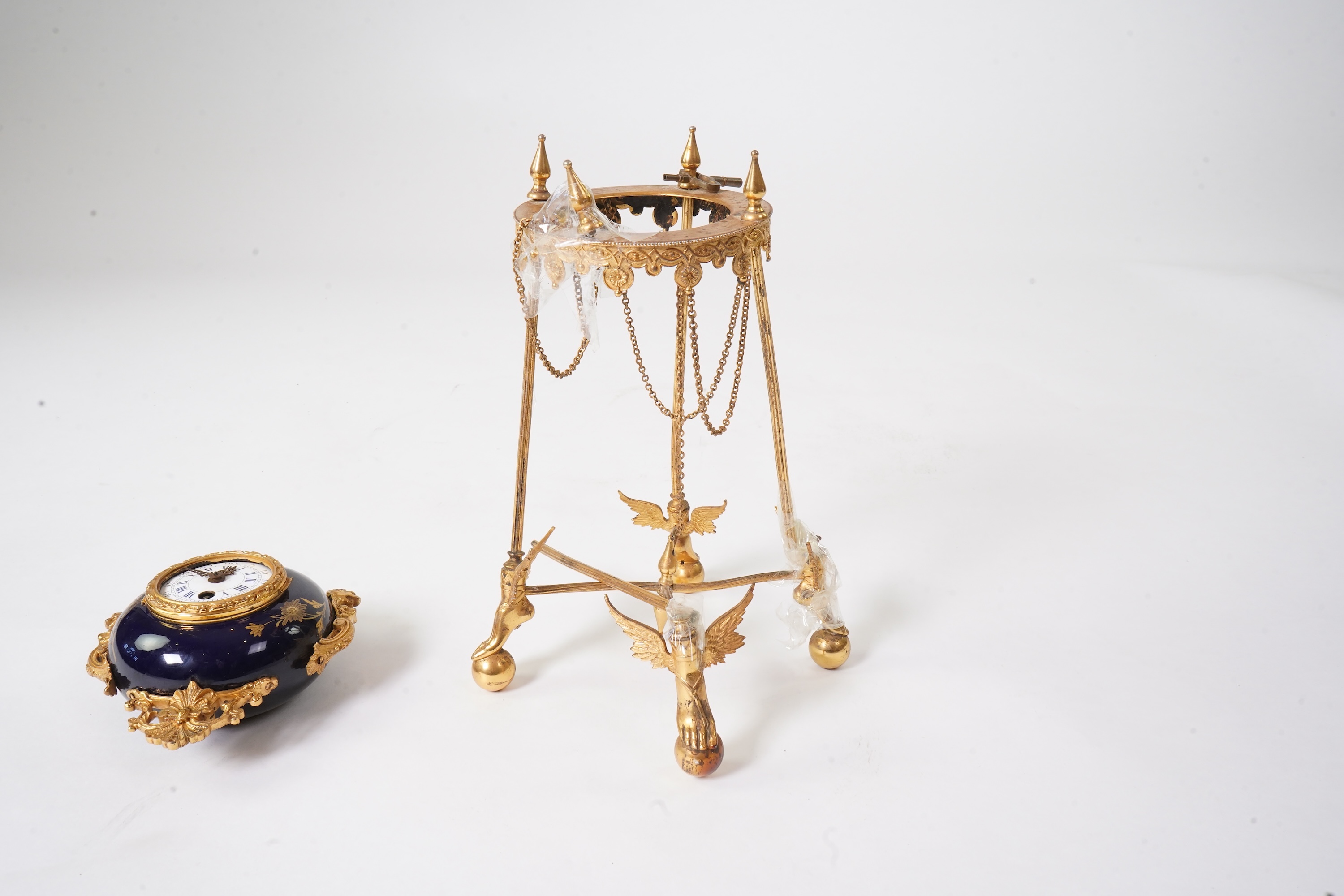 An unusual enamel and gilt brass timepiece, pendant from gilt brass frame, stand 26cm high. Condition - dismantled